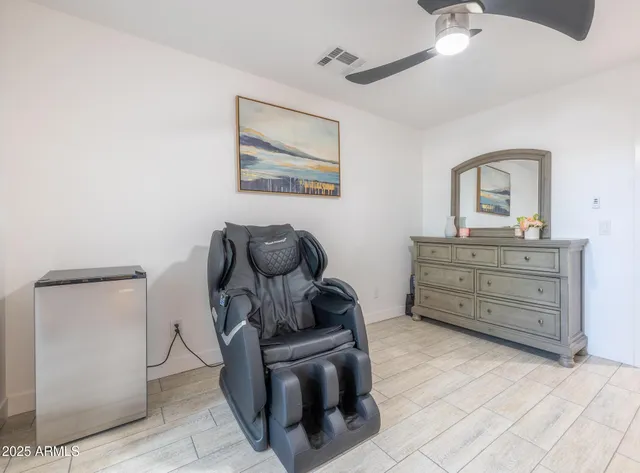 a living room with furniture and a dresser