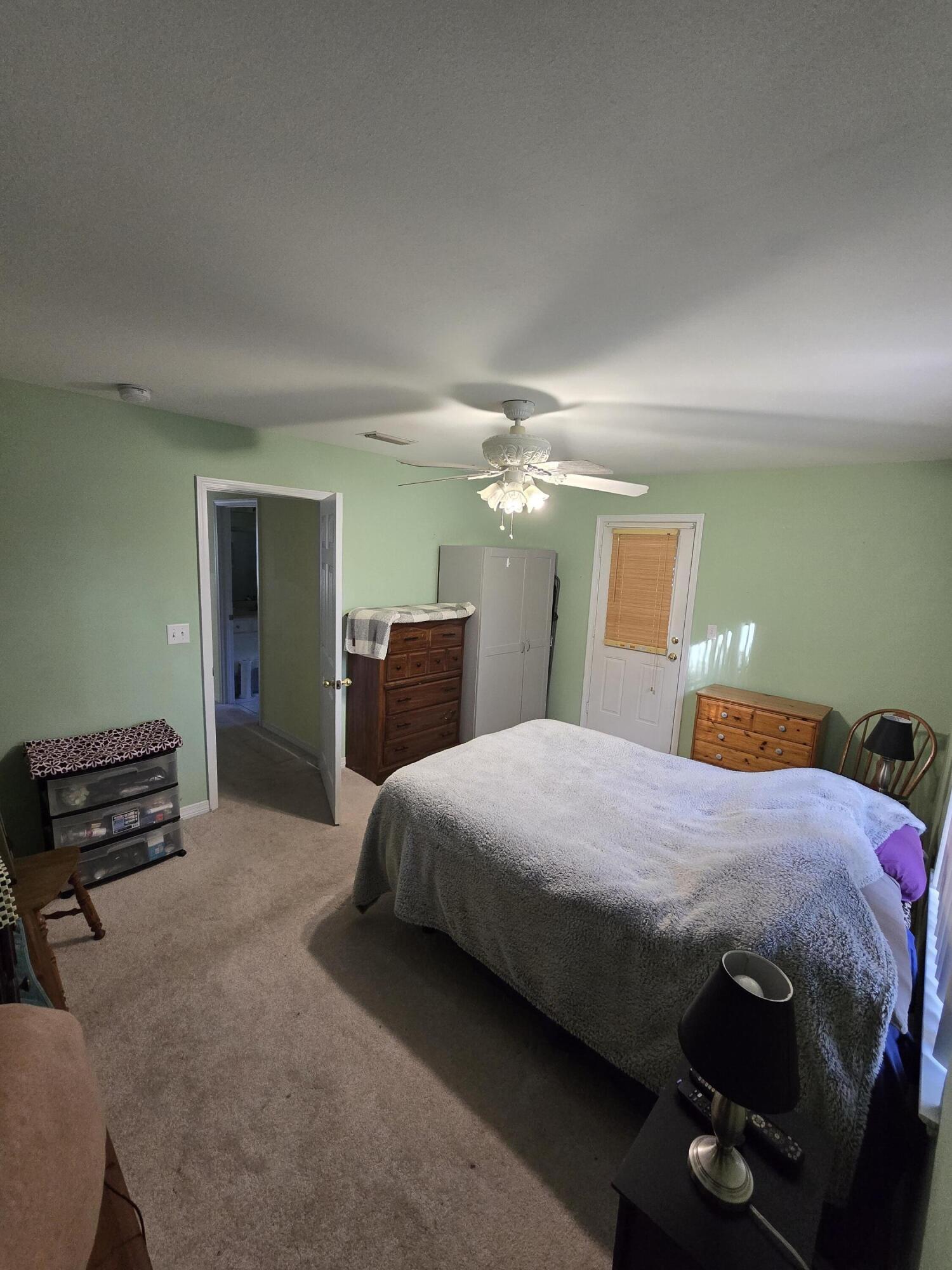 413 Ed Street Fort Walton Beach, FL 32547 - Photo 21 of 36 a bedroom with a bed and a lamp