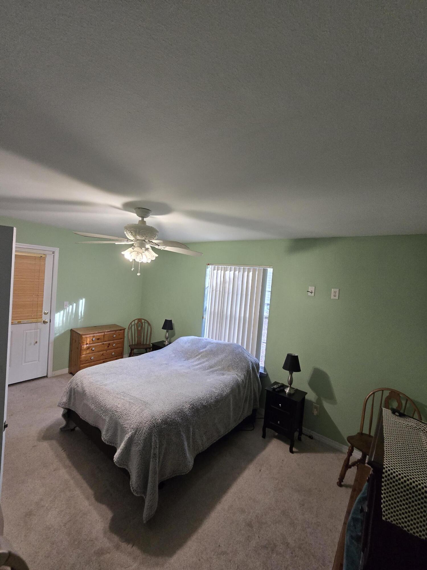 413 Ed Street Fort Walton Beach, FL 32547 - Photo 22 of 36 a bedroom with a bed and a chandelier
