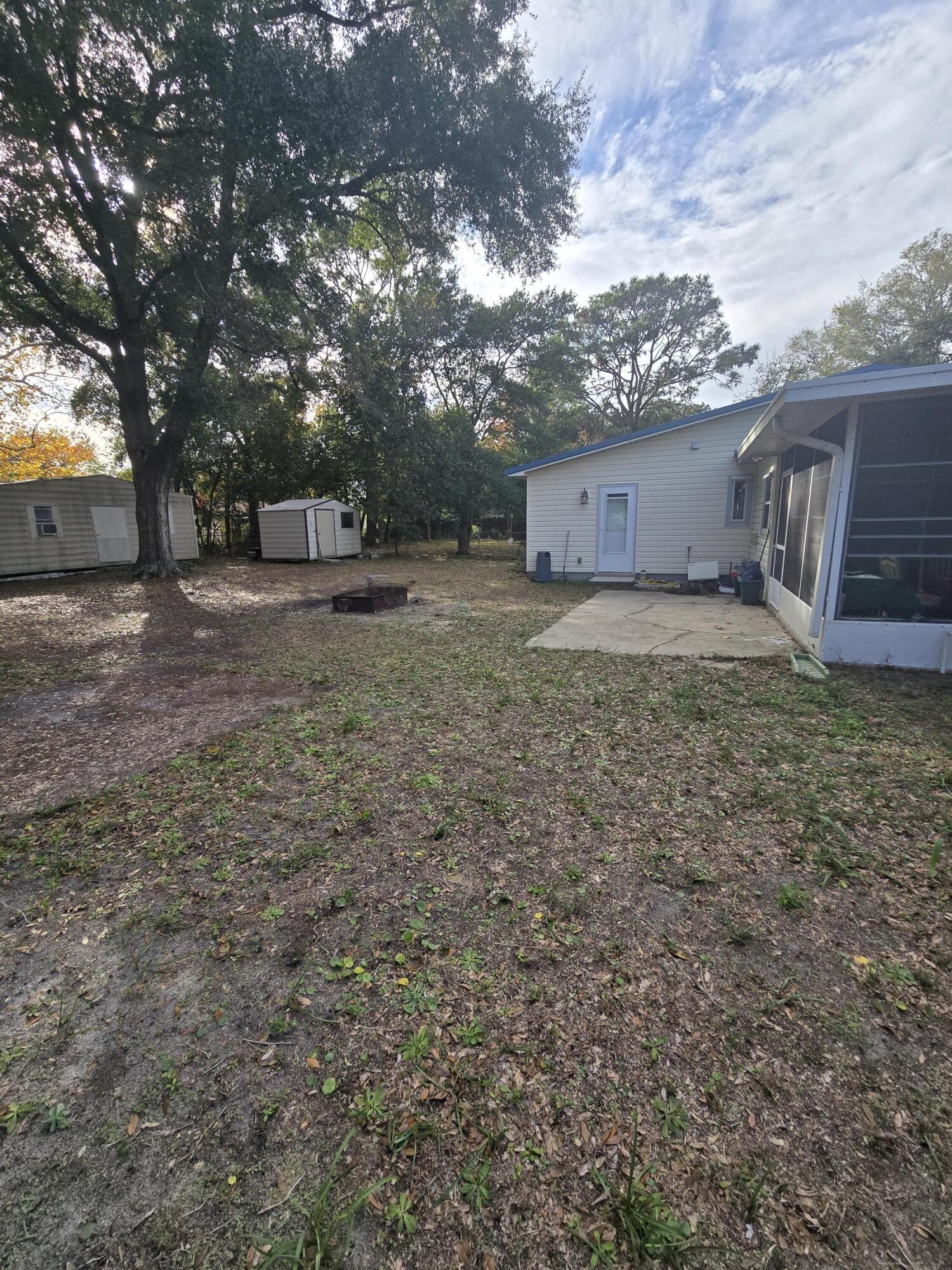 413 Ed Street Fort Walton Beach, FL 32547 - Photo 32 of 36 a view of a yard with large trees