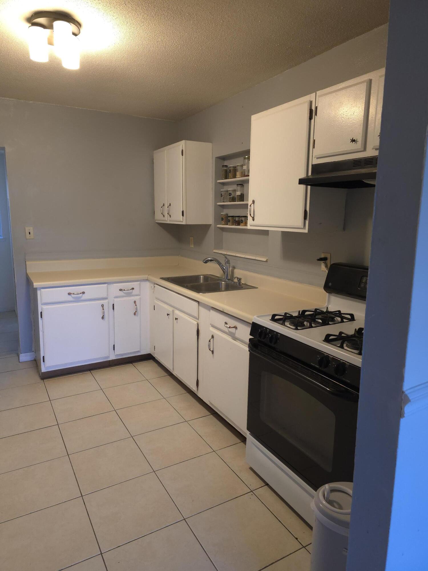 413 Ed Street Fort Walton Beach, FL 32547 - Photo 5 of 36 a kitchen with a stove and a sink