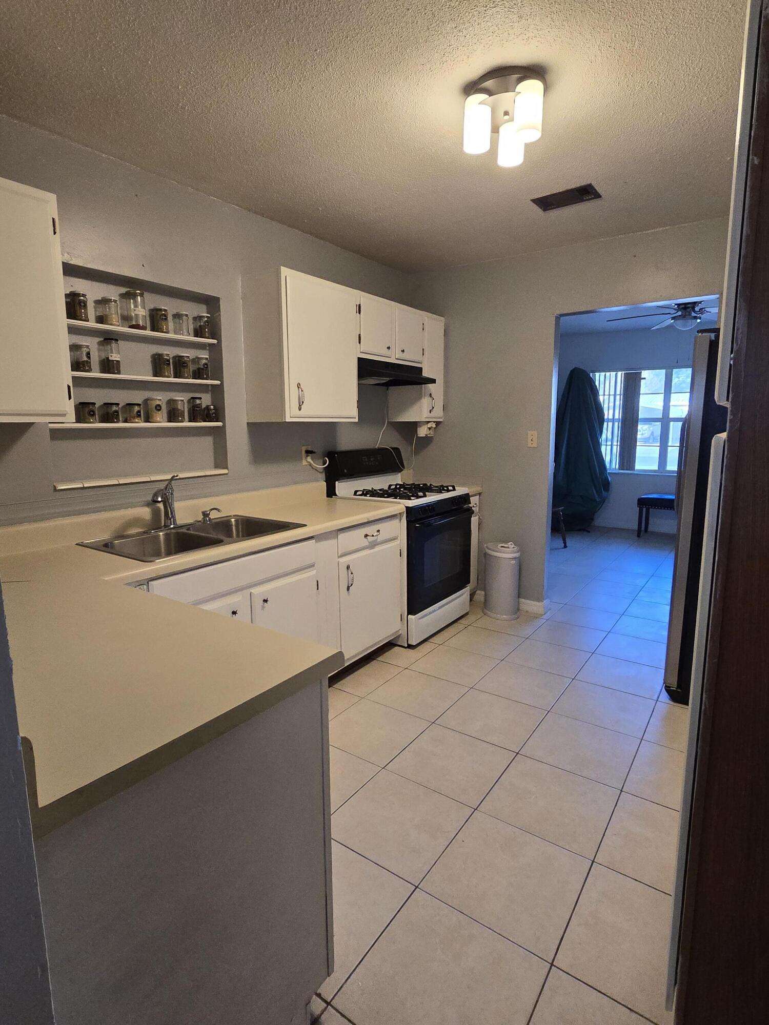 413 Ed Street Fort Walton Beach, FL 32547 - Photo 6 of 36 a kitchen with a sink a stove and cabinets