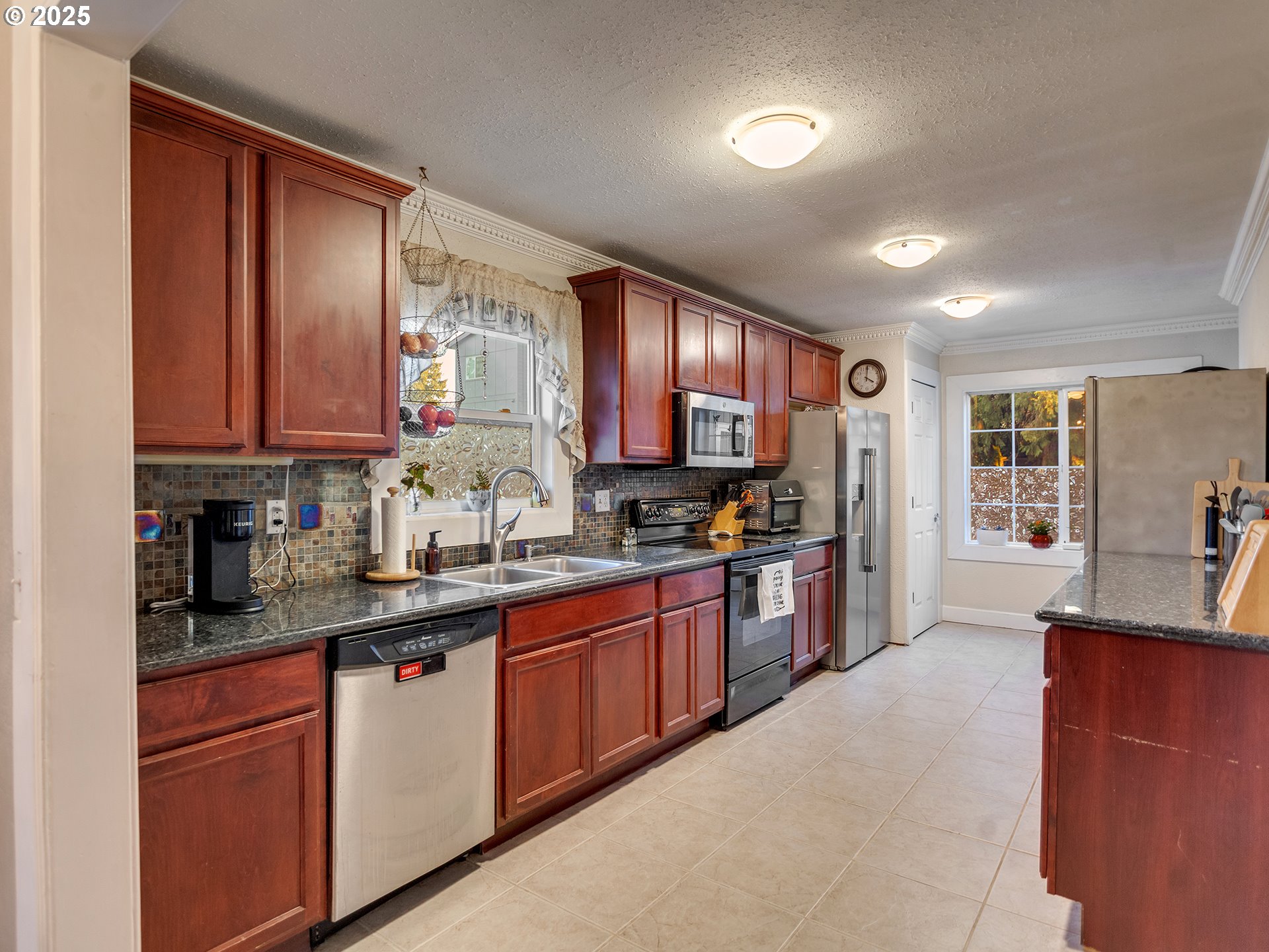 299 Southwest 3rd Avenue Canby, OR 97013 - Photo 7 of 32 a kitchen with stainless steel appliances granite countertop a sink stove and cabinets