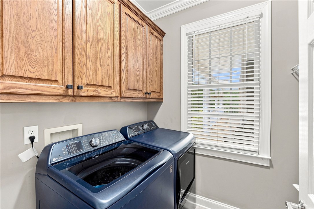 320 Watson Road Easley, SC 29642 - Photo 24 of 50 Sturdy wood cabinetry and a classic multi-pane window elevate this dedicated laundry space.