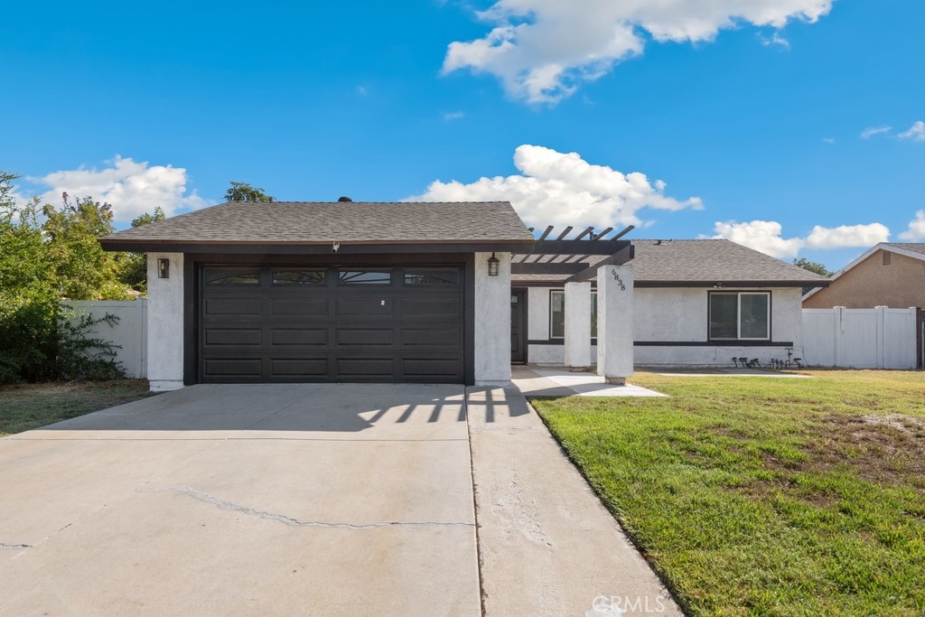 6838 Phoenix Avenue Riverside, CA 92504 - Photo 1 of 1 a front view of a house with a garden and yard