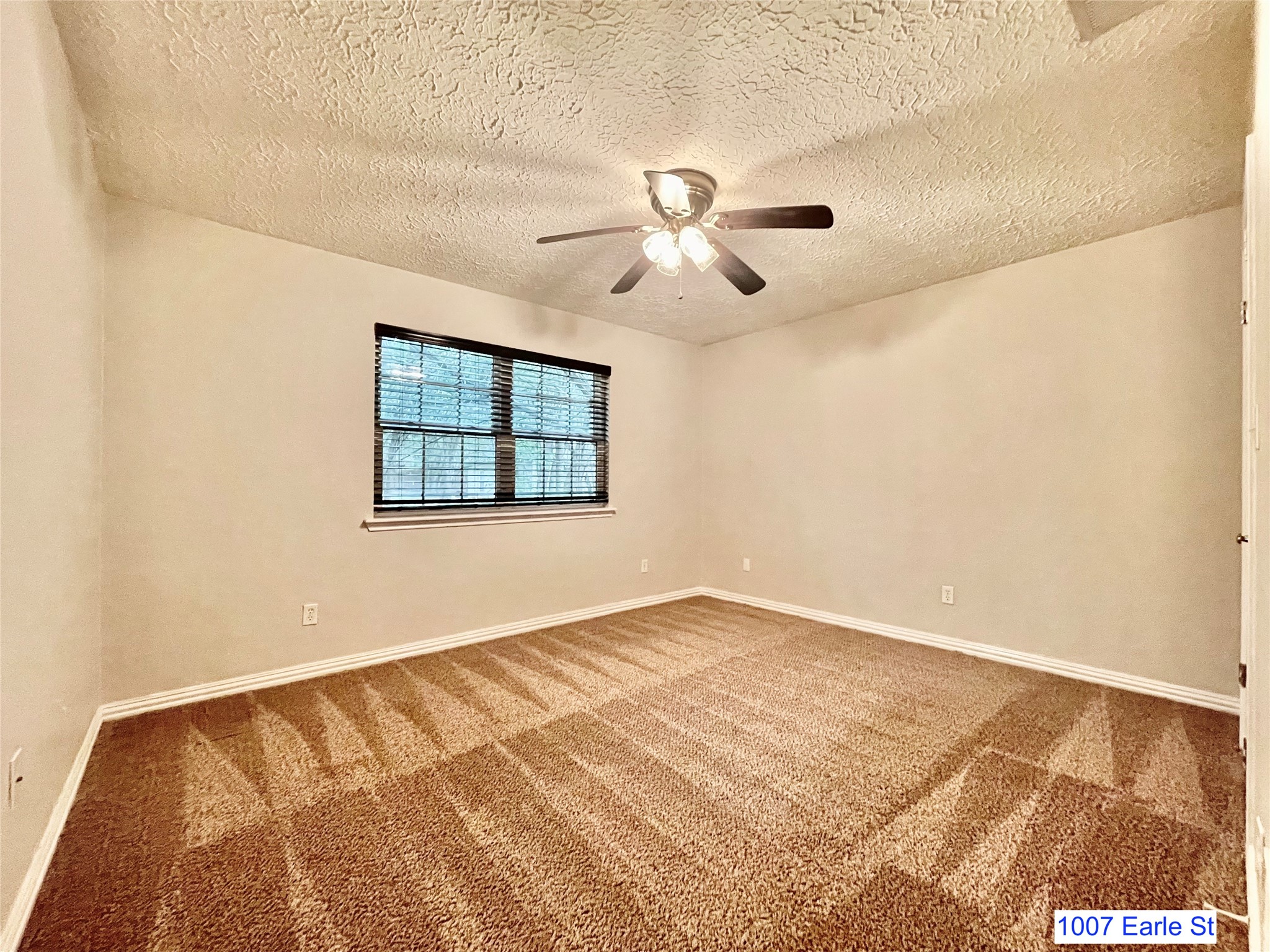 1007-1015 Earle Street San Marcos, TX 78666 - Photo 11 of 25 a view of an empty room with a window