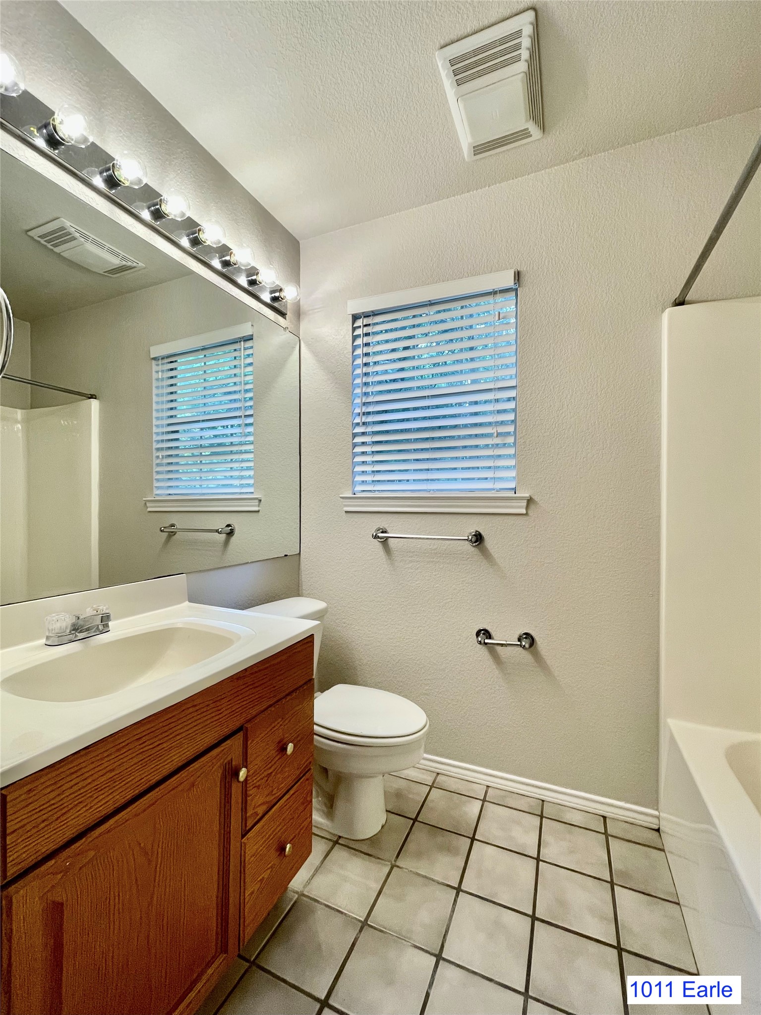 1007-1015 Earle Street San Marcos, TX 78666 - Photo 19 of 25 a bathroom with a sink a toilet and mirror
