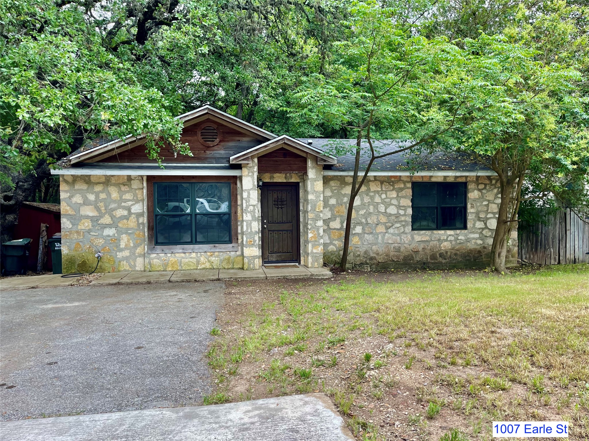 1007-1015 Earle Street San Marcos, TX 78666 - Photo 2 of 25 a front view of a house with garden