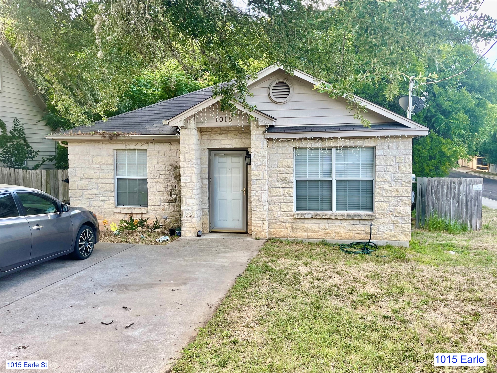 1007-1015 Earle Street San Marcos, TX 78666 - Photo 24 of 25 a front view of a house with a yard and garage