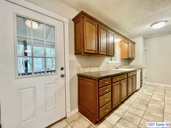 a kitchen with stainless steel appliances granite countertop a sink and a stove