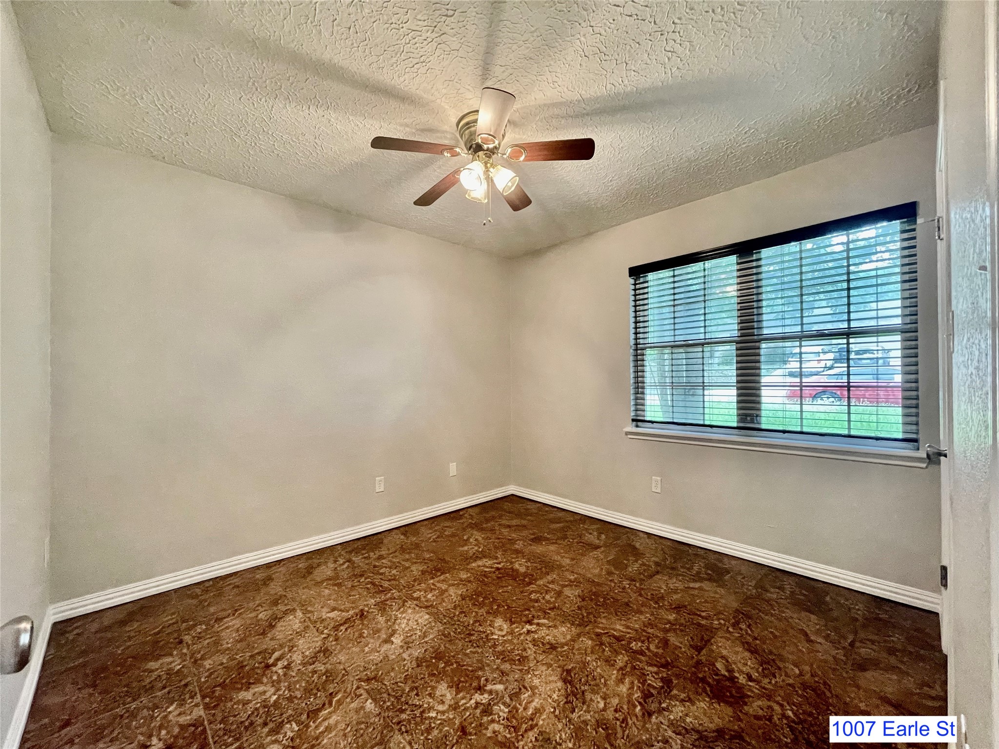 1007-1015 Earle Street San Marcos, TX 78666 - Photo 8 of 25 an empty room with windows and fan