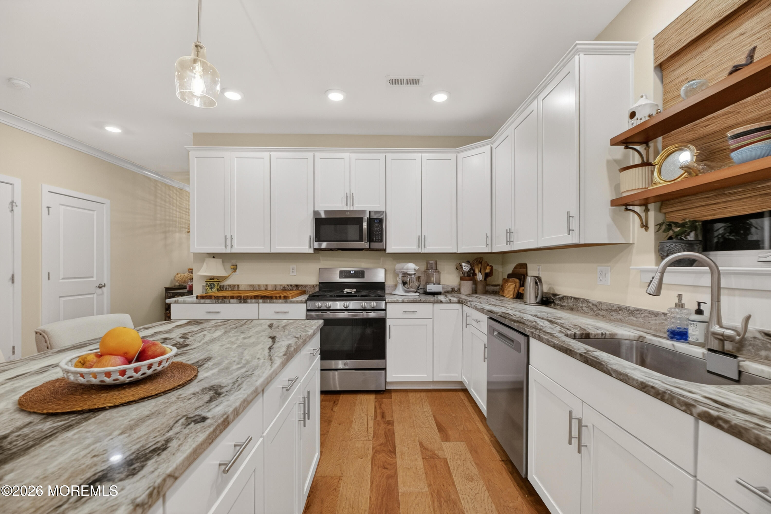 35 Saratoga Road New Egypt, NJ 08533 - Photo 15 of 43 a kitchen with stainless steel appliances granite countertop a sink dishwasher stove and white cabinets with wooden floor