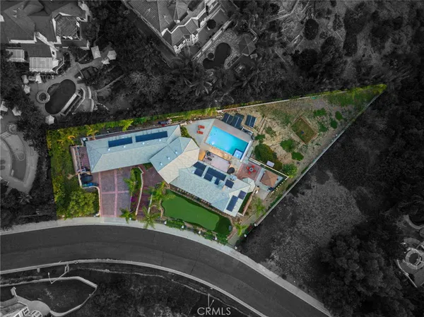 an aerial view of a house with a street