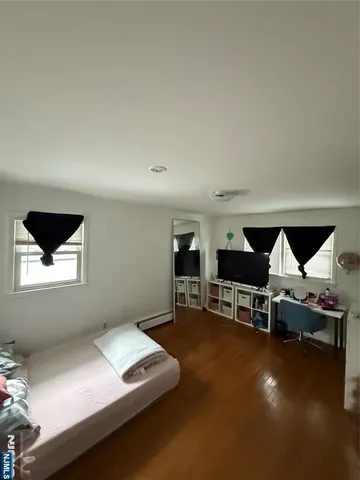 a living room with furniture pool table and window