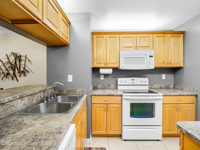 a kitchen with stainless steel appliances granite countertop a sink and a stove