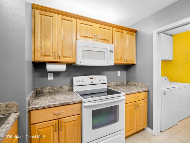a kitchen with granite countertop cabinets stainless steel appliances and a sink