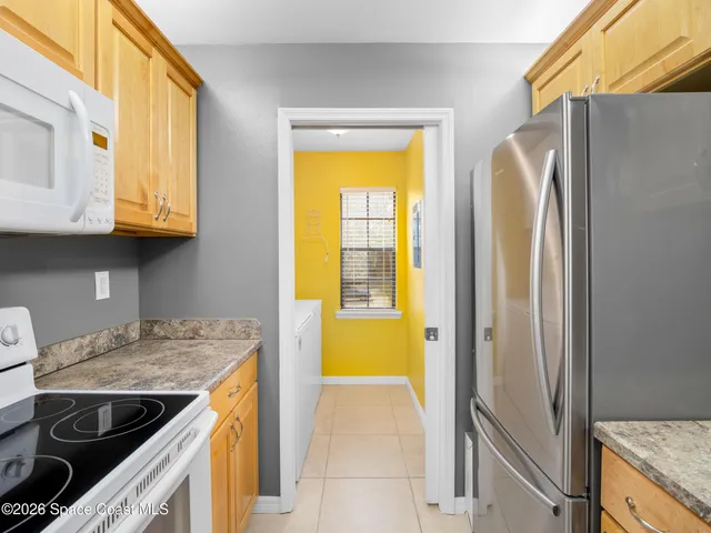 a kitchen with a stove a sink and a refrigerator