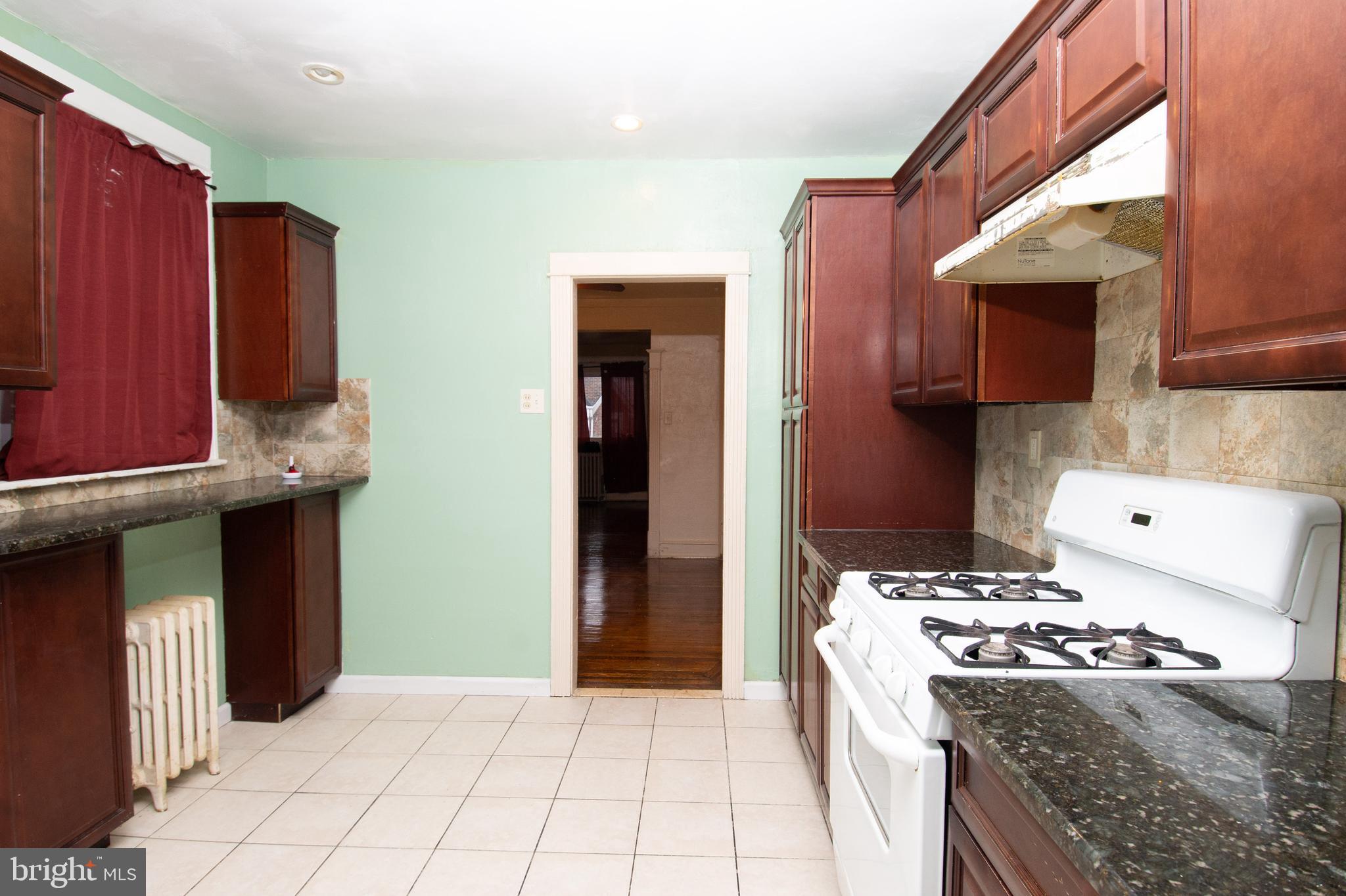 291 Sanford Road Upper Darby, PA 19082 - Photo 4 of 18 a kitchen with stainless steel appliances granite countertop a stove a refrigerator and a microwave