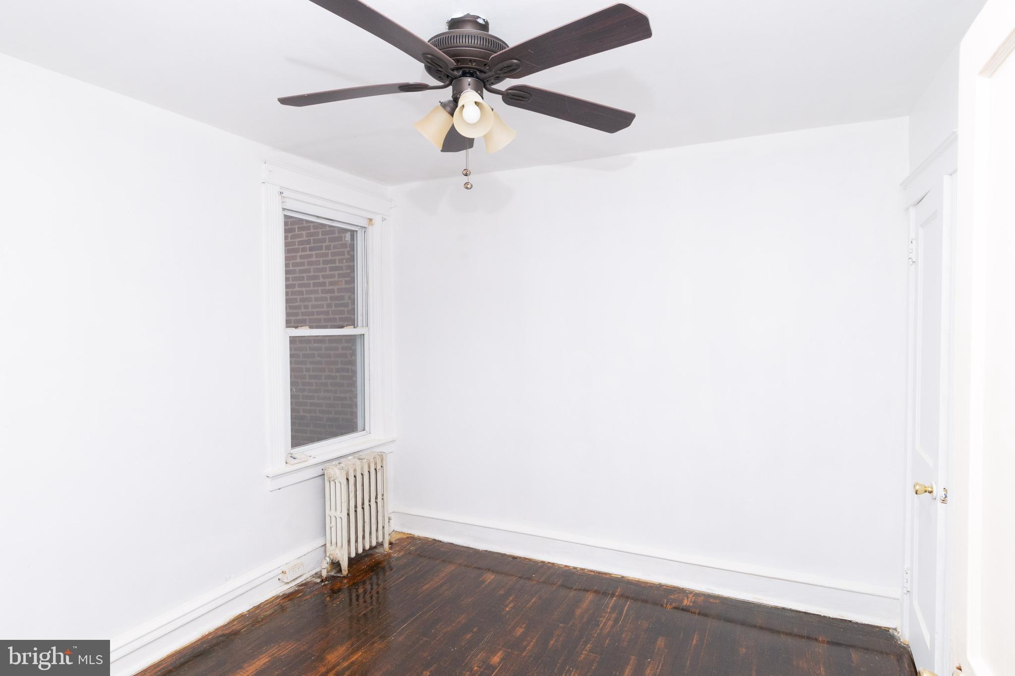 291 Sanford Road Upper Darby, PA 19082 - Photo 7 of 18 an empty room with a window and a ceiling fan