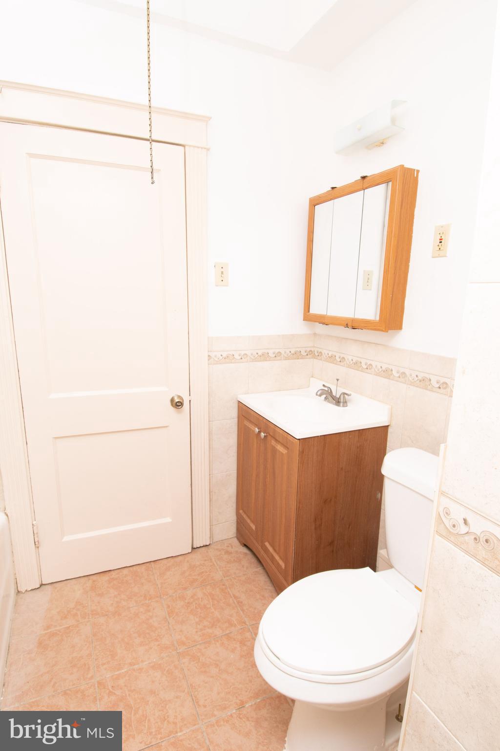 291 Sanford Road Upper Darby, PA 19082 - Photo 8 of 18 a bathroom with a sink a toilet a mirror and shower
