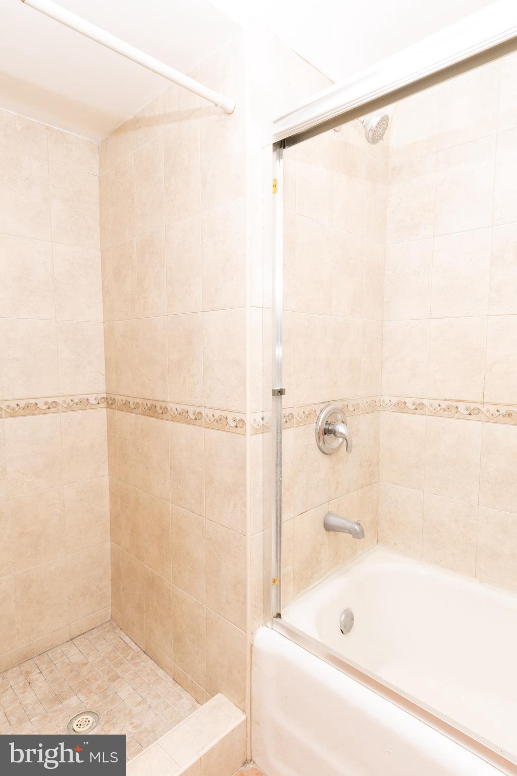 291 Sanford Road Upper Darby, PA 19082 - Photo 10 of 18 a bathroom with a bathtub and a shower