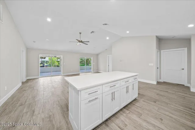 a kitchen with a sink cabinets stainless steel appliances and a window
