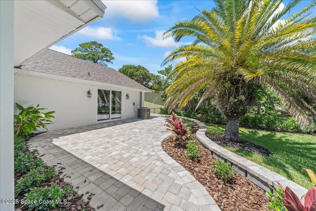 a large kitchen with a large counter top and stainless steel appliances
