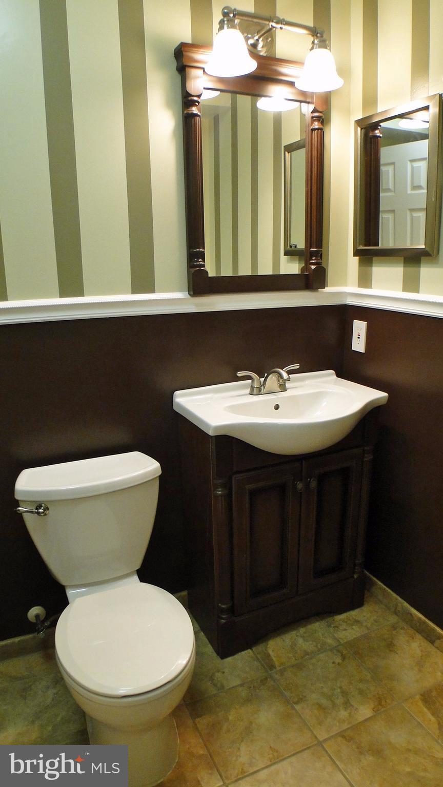 2230 Riding Crop Way Baltimore, MD 21244 - Photo 14 of 18 a bathroom with a toilet sink and mirror