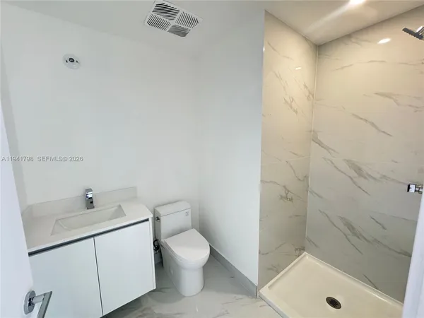 a bathroom with a sink a toilet and bathtub