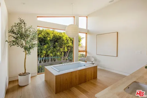 a view of room with wooden floor and windows