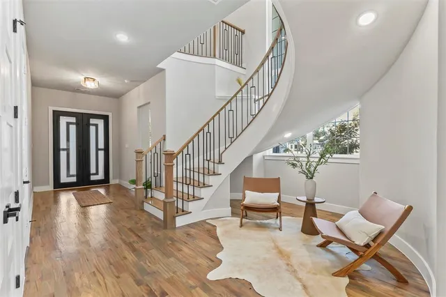 a view of entryway and hall with wooden floor