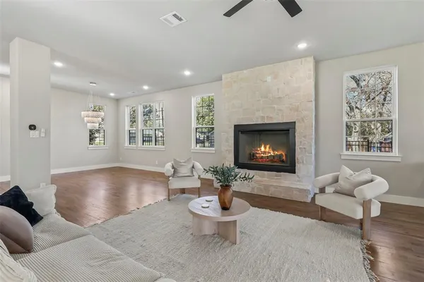 a large kitchen with kitchen island white cabinets and stainless steel appliances