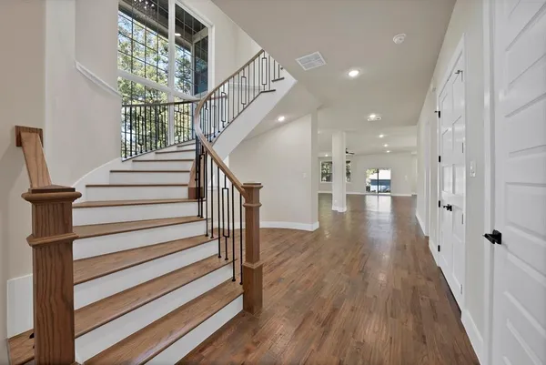a view of entryway and hall with wooden floor
