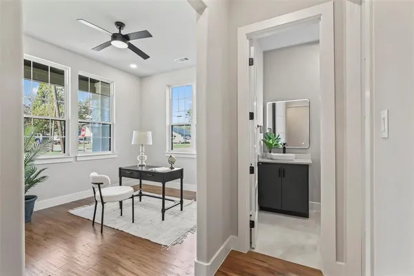 a view of a livingroom with furniture wooden floor and windows