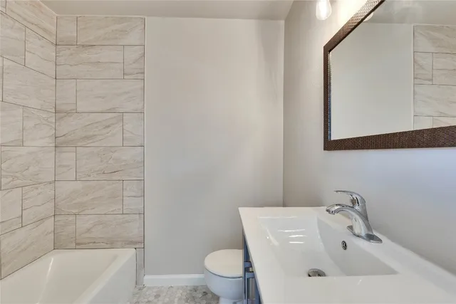 a bathroom with a white sink a toilet and bathtub