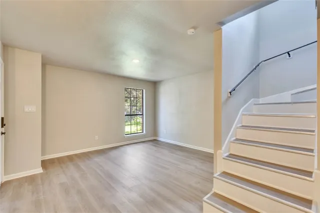 a view of entryway with wooden floor and front door