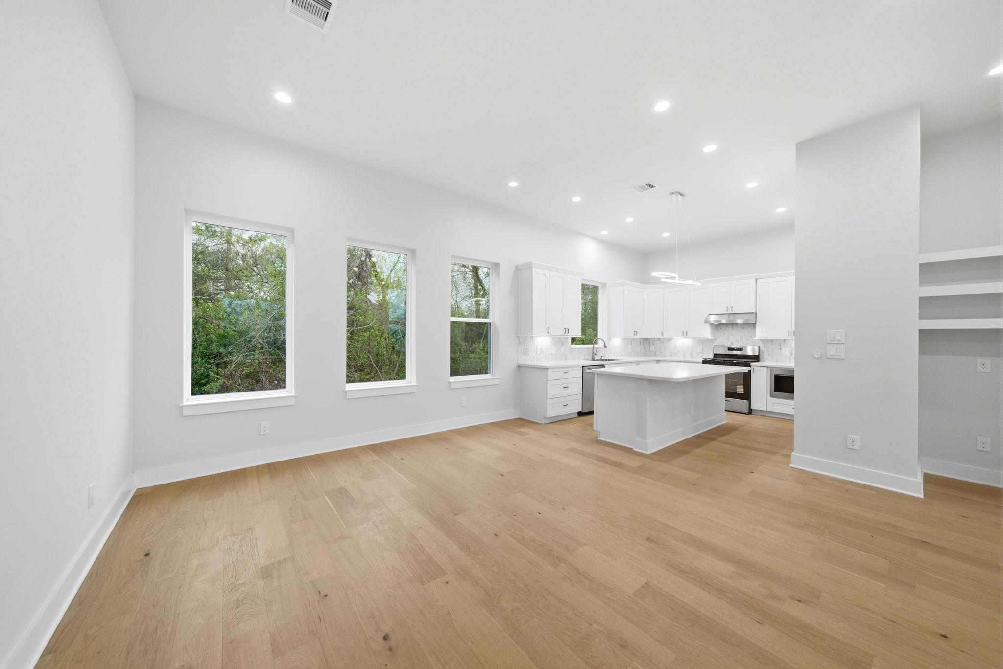 330 Janisch Road, Unit A Houston, TX 77018 - Photo 13 of 40 a view of kitchen with white cabinets and wooden floor