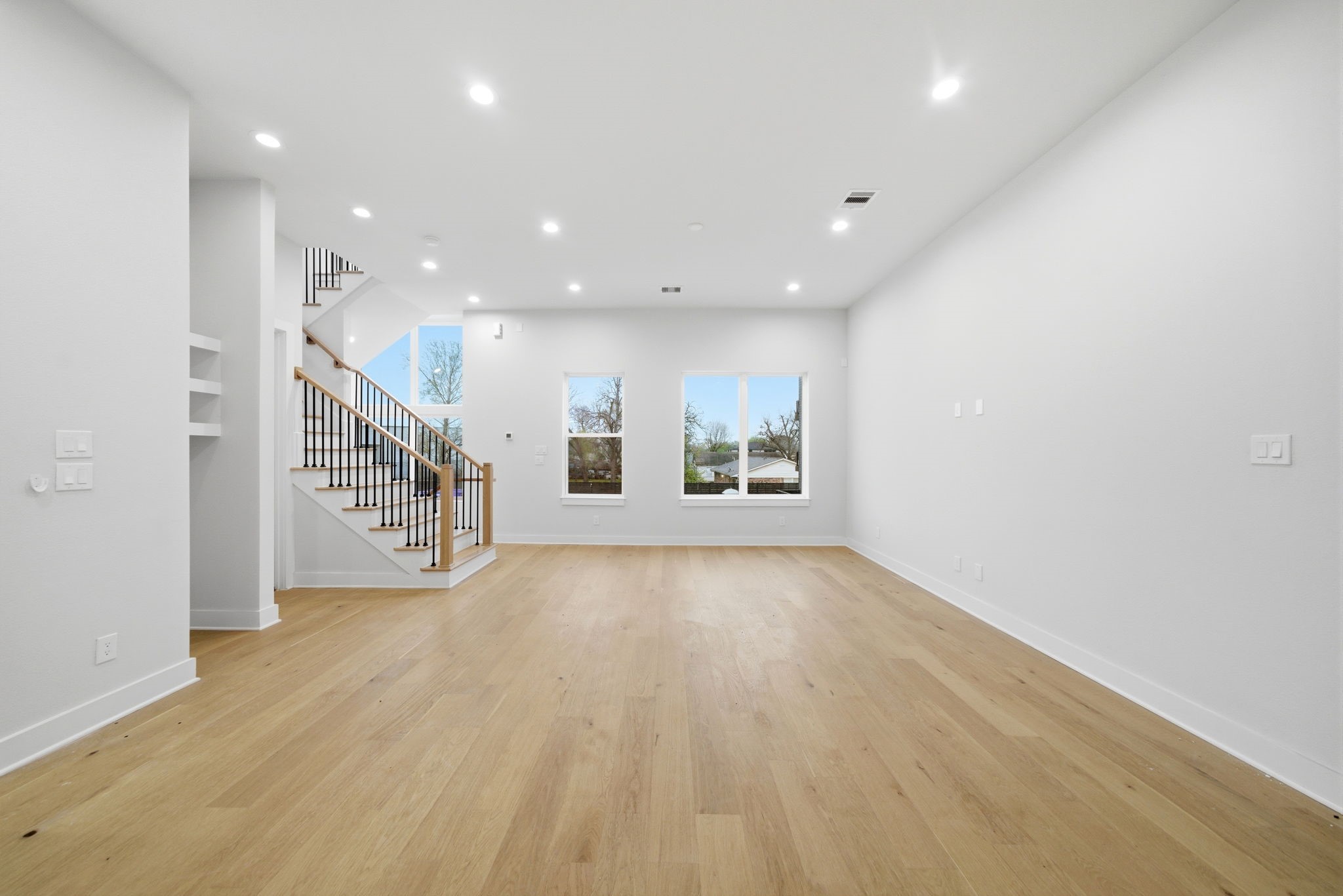 330 Janisch Road, Unit A Houston, TX 77018 - Photo 14 of 40 a view of an empty room with wooden floor and a window