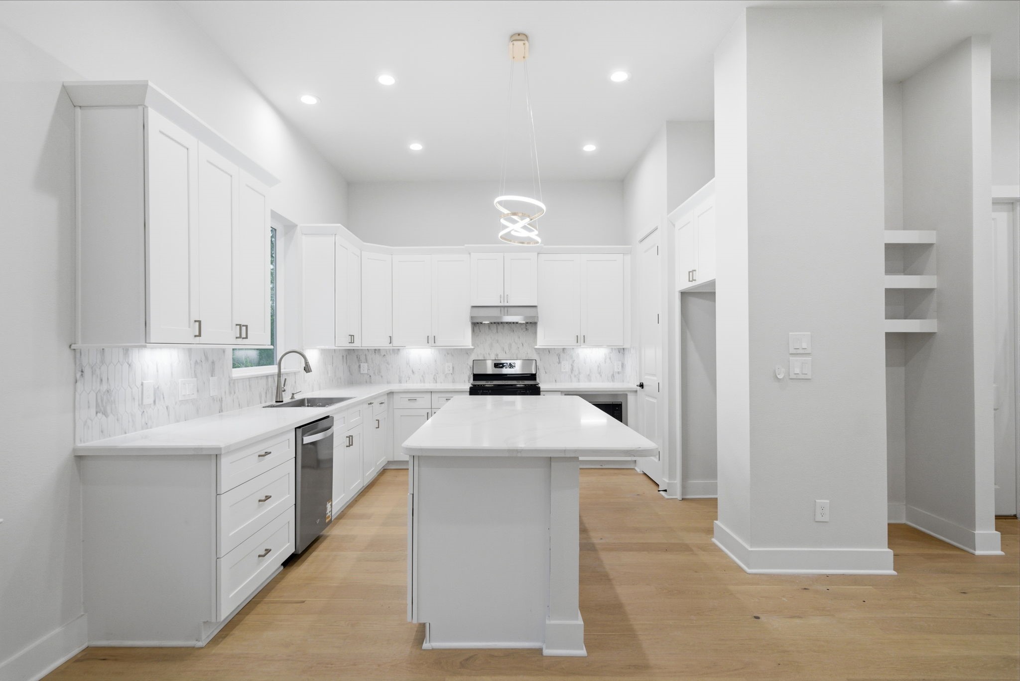 330 Janisch Road, Unit A Houston, TX 77018 - Photo 15 of 40 a large kitchen with stainless steel appliances kitchen island granite countertop a sink and cabinets