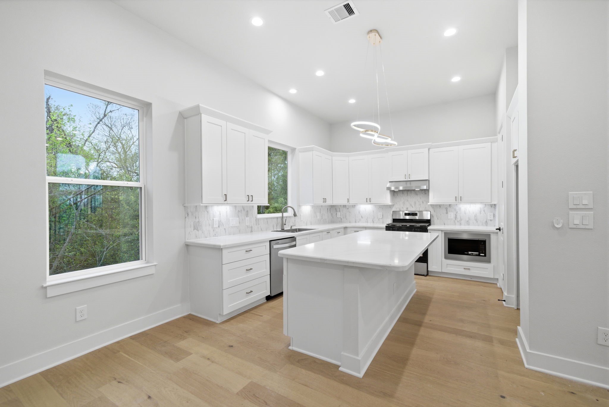 330 Janisch Road, Unit A Houston, TX 77018 - Photo 16 of 40 a large white kitchen with a large window