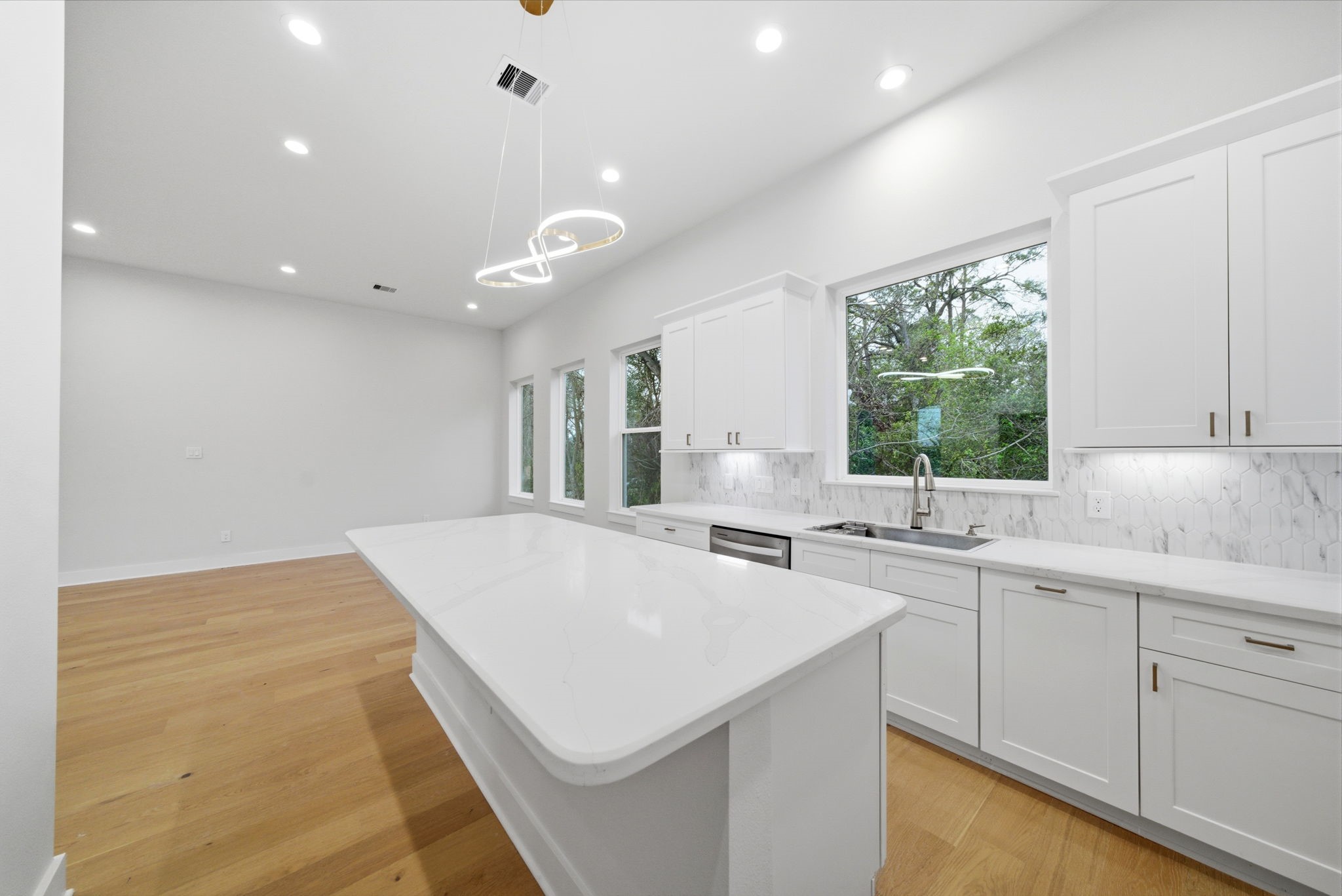 330 Janisch Road, Unit A Houston, TX 77018 - Photo 18 of 40 a large white kitchen with a sink a window and cabinets