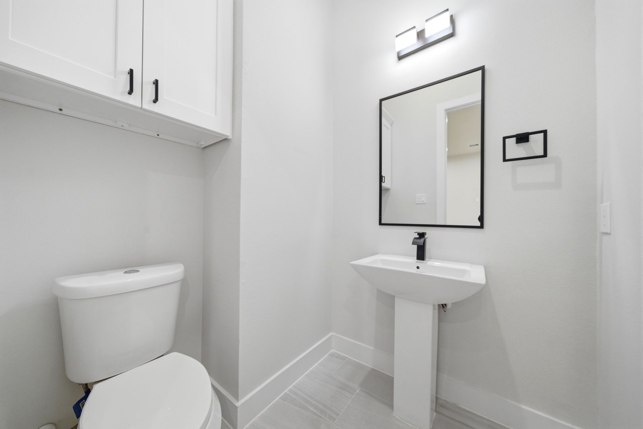 330 Janisch Road, Unit A Houston, TX 77018 - Photo 20 of 40 a bathroom with a toilet sink and mirror