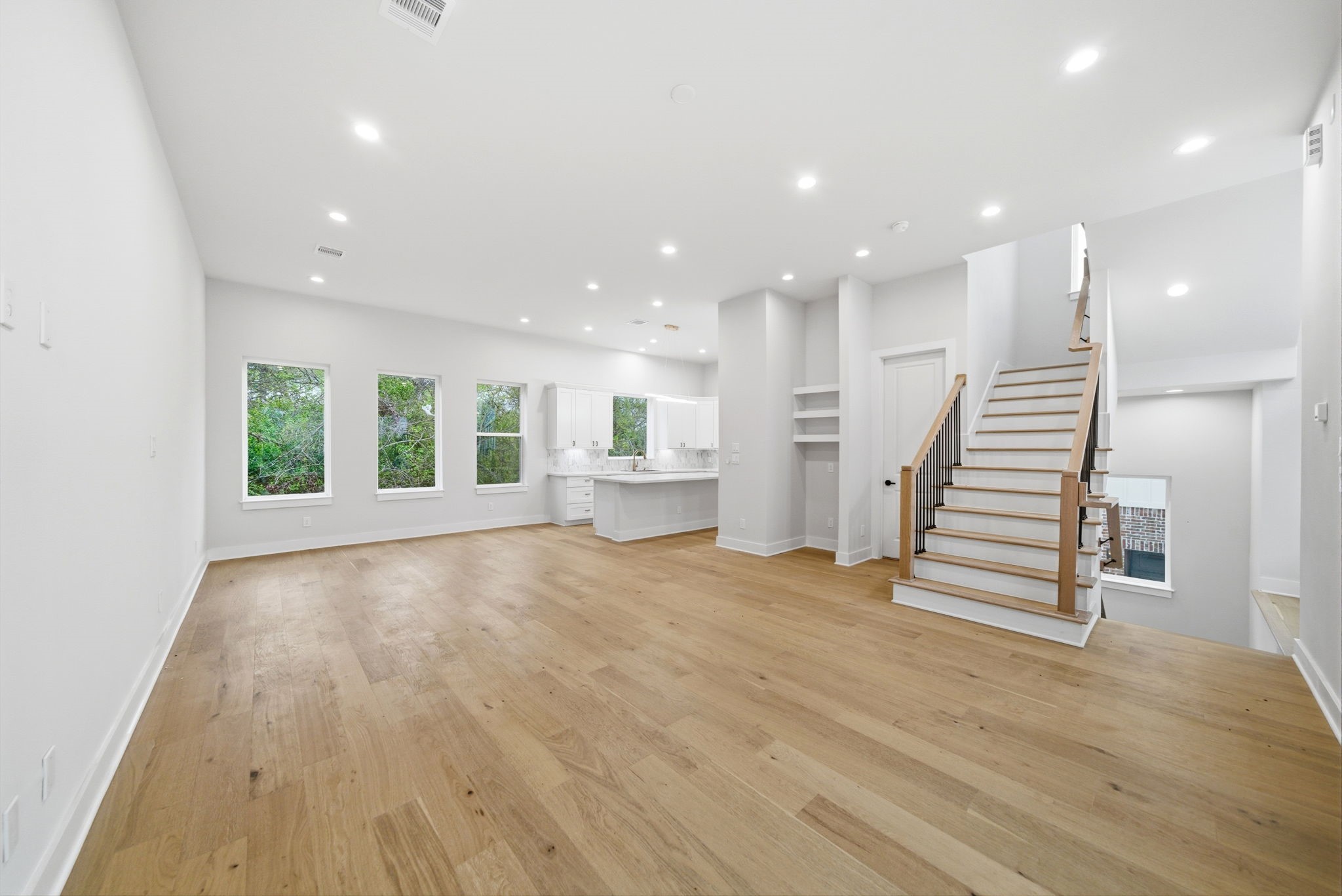 330 Janisch Road, Unit A Houston, TX 77018 - Photo 9 of 40 a view of an empty room with wooden floor and stairs