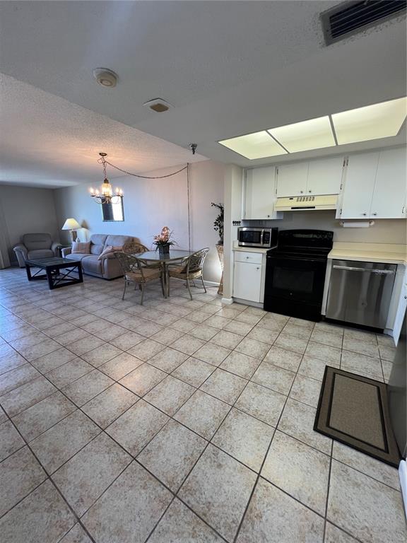 5915 Sea Ranch Drive, Unit 512 Hudson, FL 34667 - Photo 11 of 55 a kitchen with stainless steel appliances kitchen island granite countertop a sink and a stove