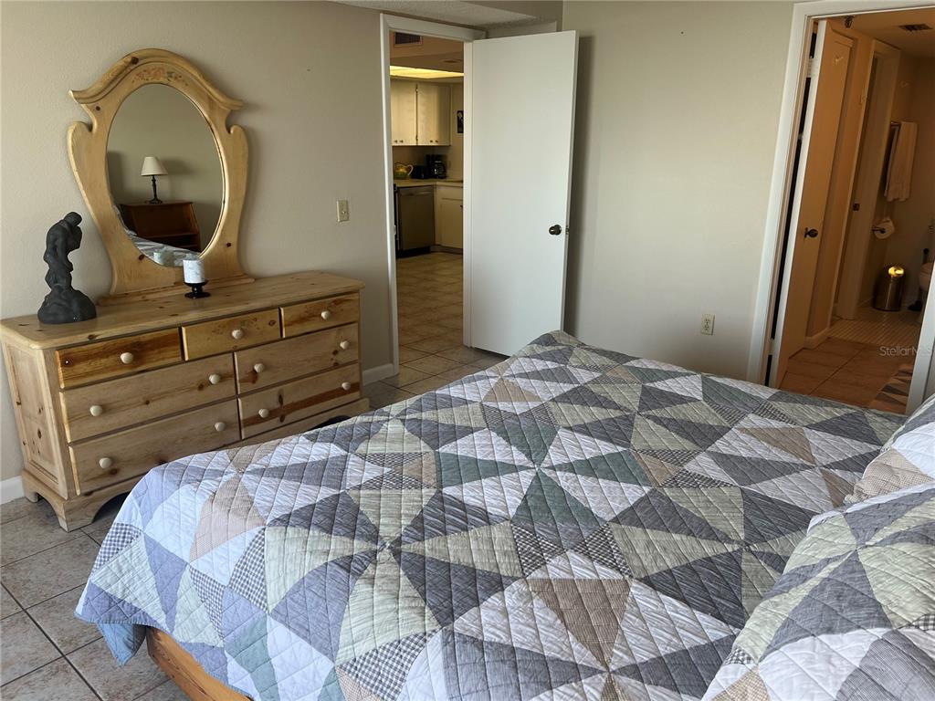 5915 Sea Ranch Drive, Unit 512 Hudson, FL 34667 - Photo 18 of 55 a bedroom with a bed and a mirror