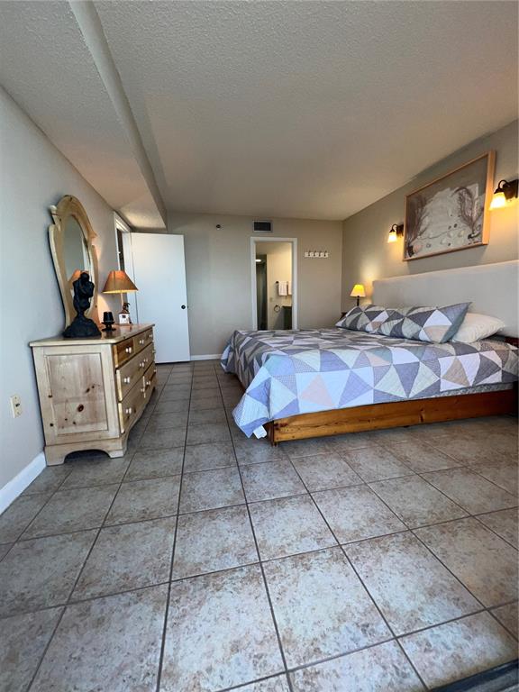 5915 Sea Ranch Drive, Unit 512 Hudson, FL 34667 - Photo 20 of 55 a spacious bedroom with a bed and window
