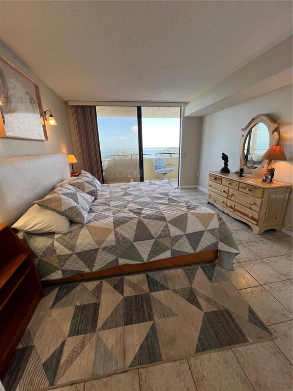 5915 Sea Ranch Drive, Unit 512 Hudson, FL 34667 - Photo 21 of 55 a bedroom with a bed and a dresser next to a window