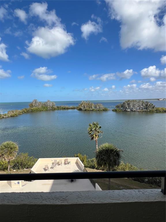 5915 Sea Ranch Drive, Unit 512 Hudson, FL 34667 - Photo 30 of 55 a view of a lake with lawn chairs