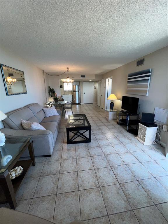 5915 Sea Ranch Drive, Unit 512 Hudson, FL 34667 - Photo 7 of 55 a living room with furniture a table and a window