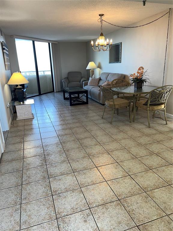 5915 Sea Ranch Drive, Unit 512 Hudson, FL 34667 - Photo 8 of 55 a living room with furniture and a chandelier